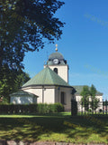 Historic Church with Clock Tower and Cross under Clear Blue Sky