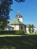 Church Building with Clock Tower and Green Roof