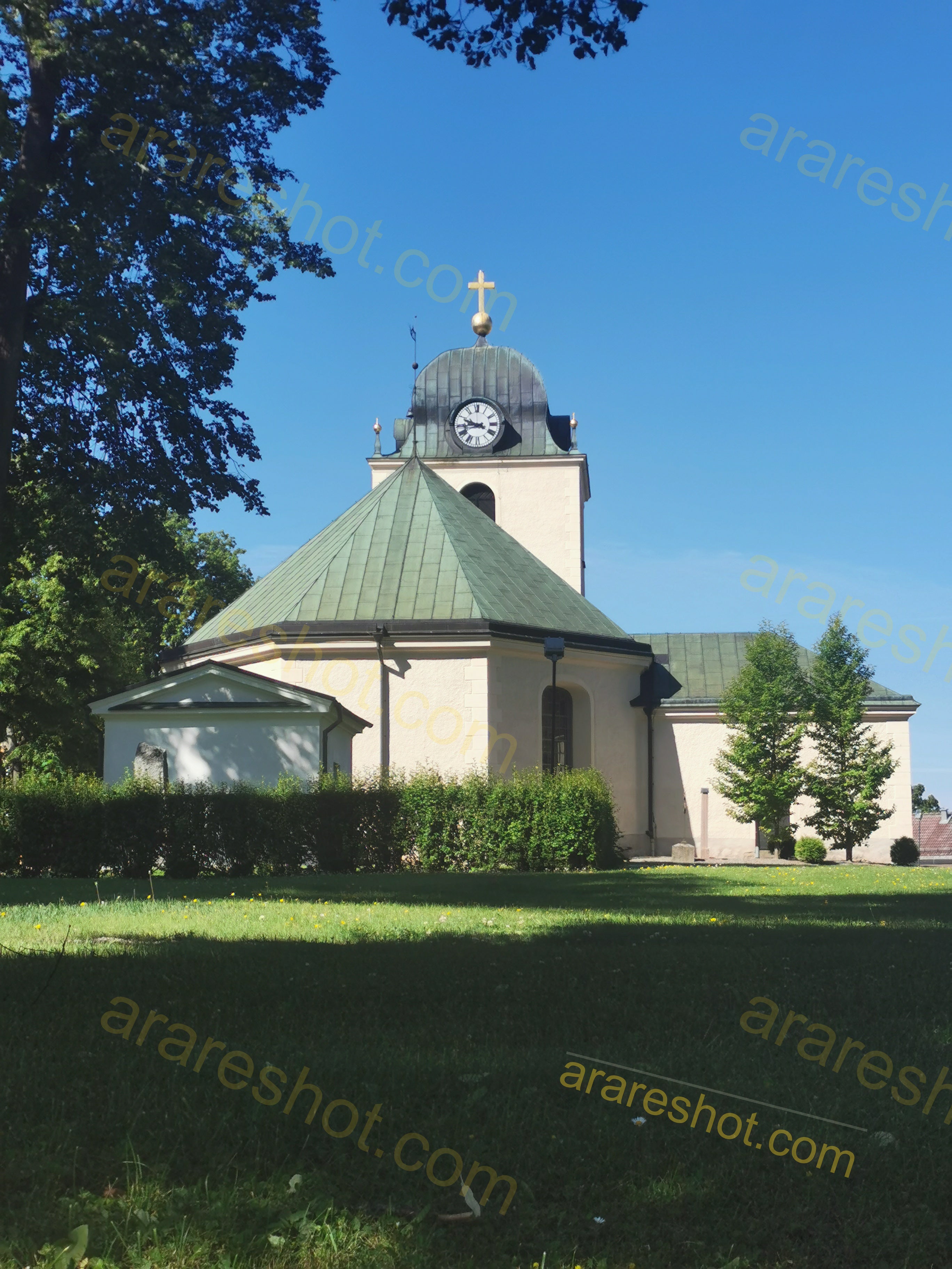 Church Building with Clock Tower and Green Roof