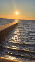 Wooden Pier on Water at Sunset