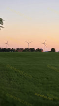 Wind Turbines on Green Field at Sunset