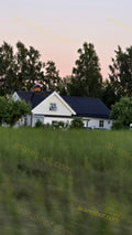 White House with Black Roof Behind Green Field