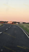 Curved Road with Farm Buildings in Background