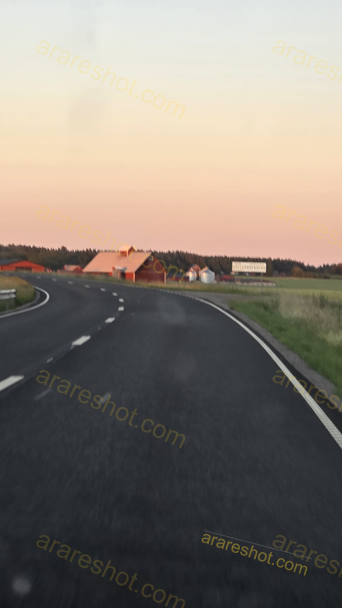 Curved Road with Farm Buildings in Background