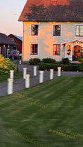 House with White Posts and Green Lawn