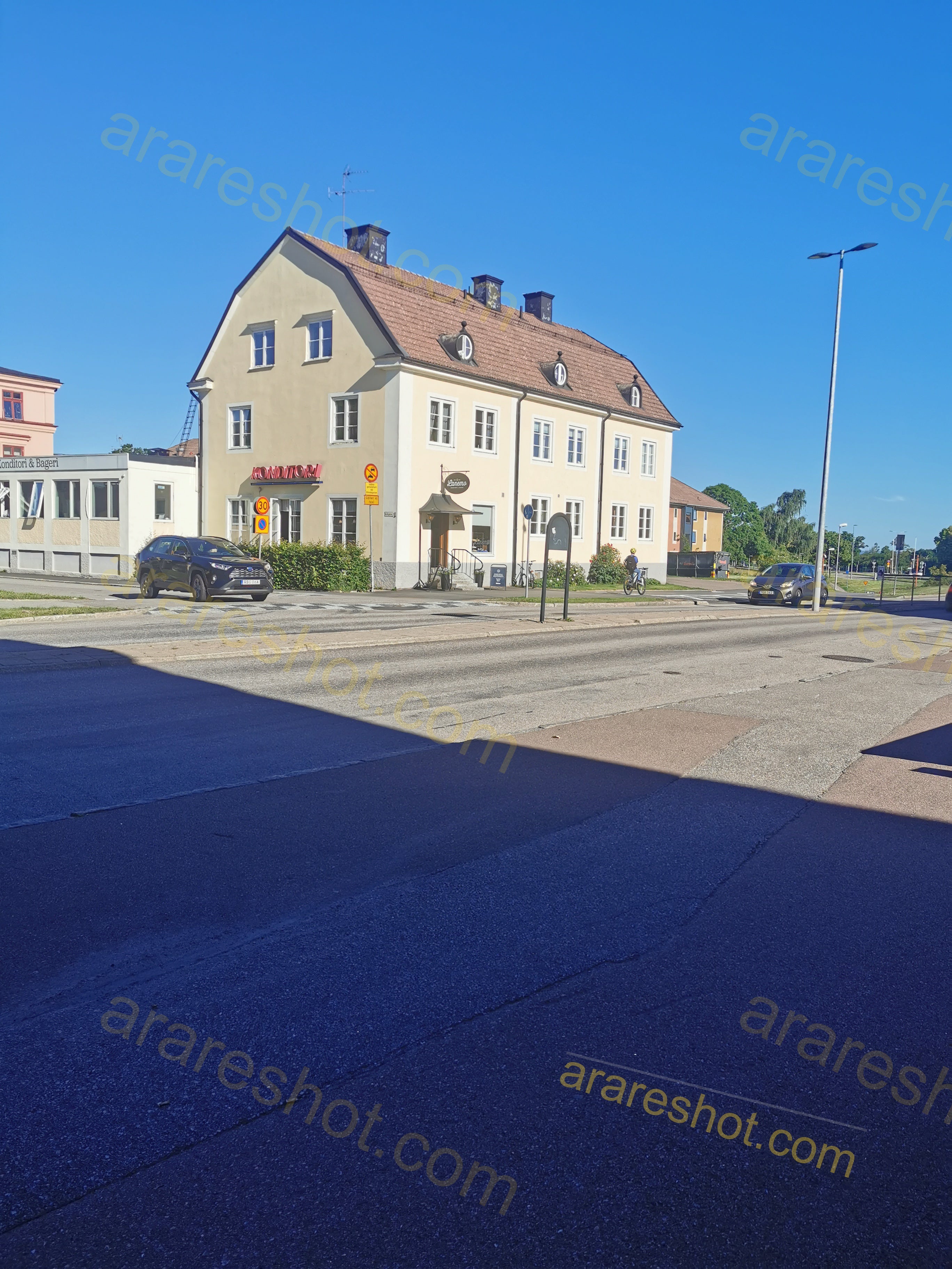 Two-Story Beige Building by Street with Cars