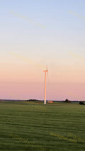 Wind Turbine on Green Field at Sunset