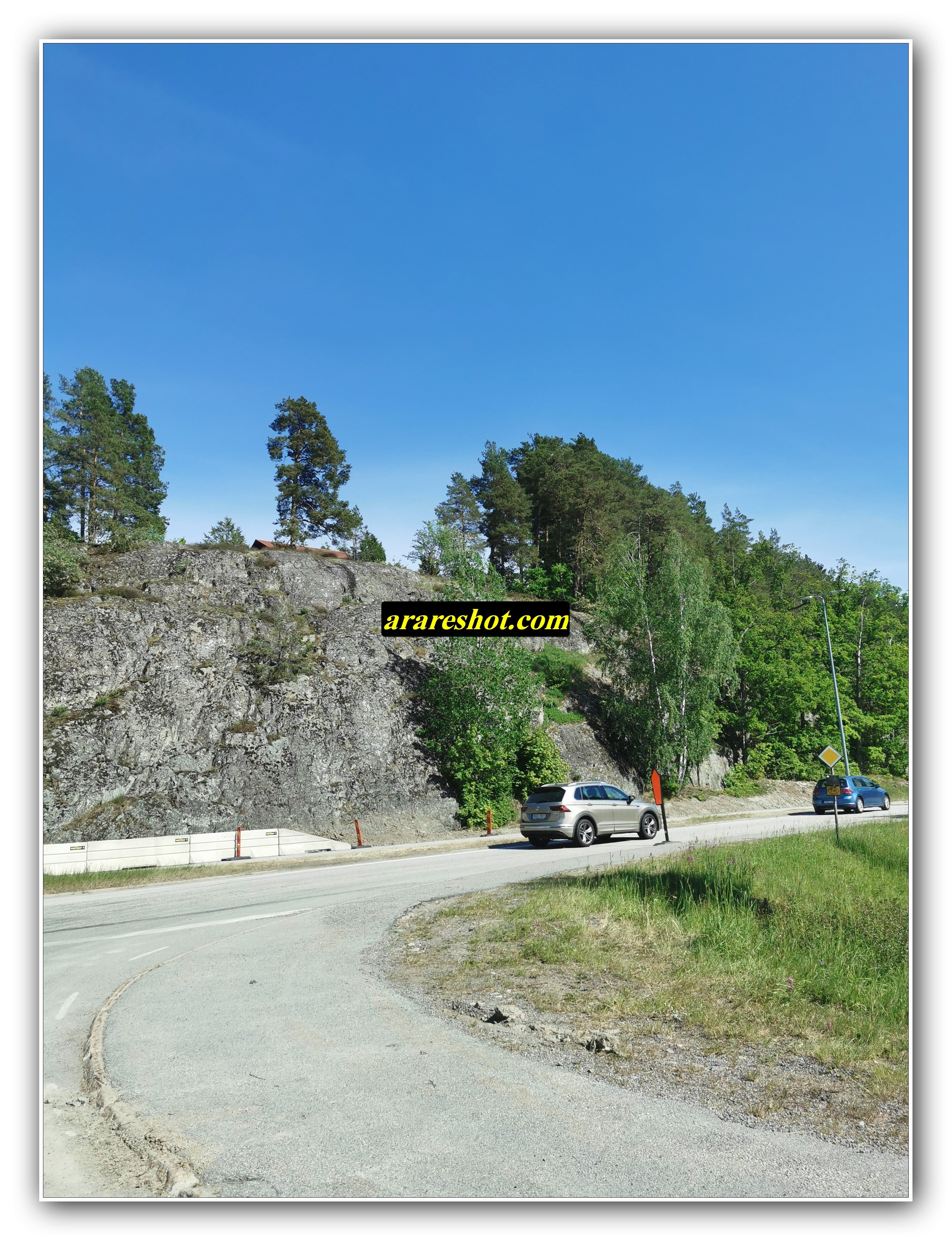 Curved Road by Rocky Hillside