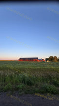 Red Farmhouse with Green Fields