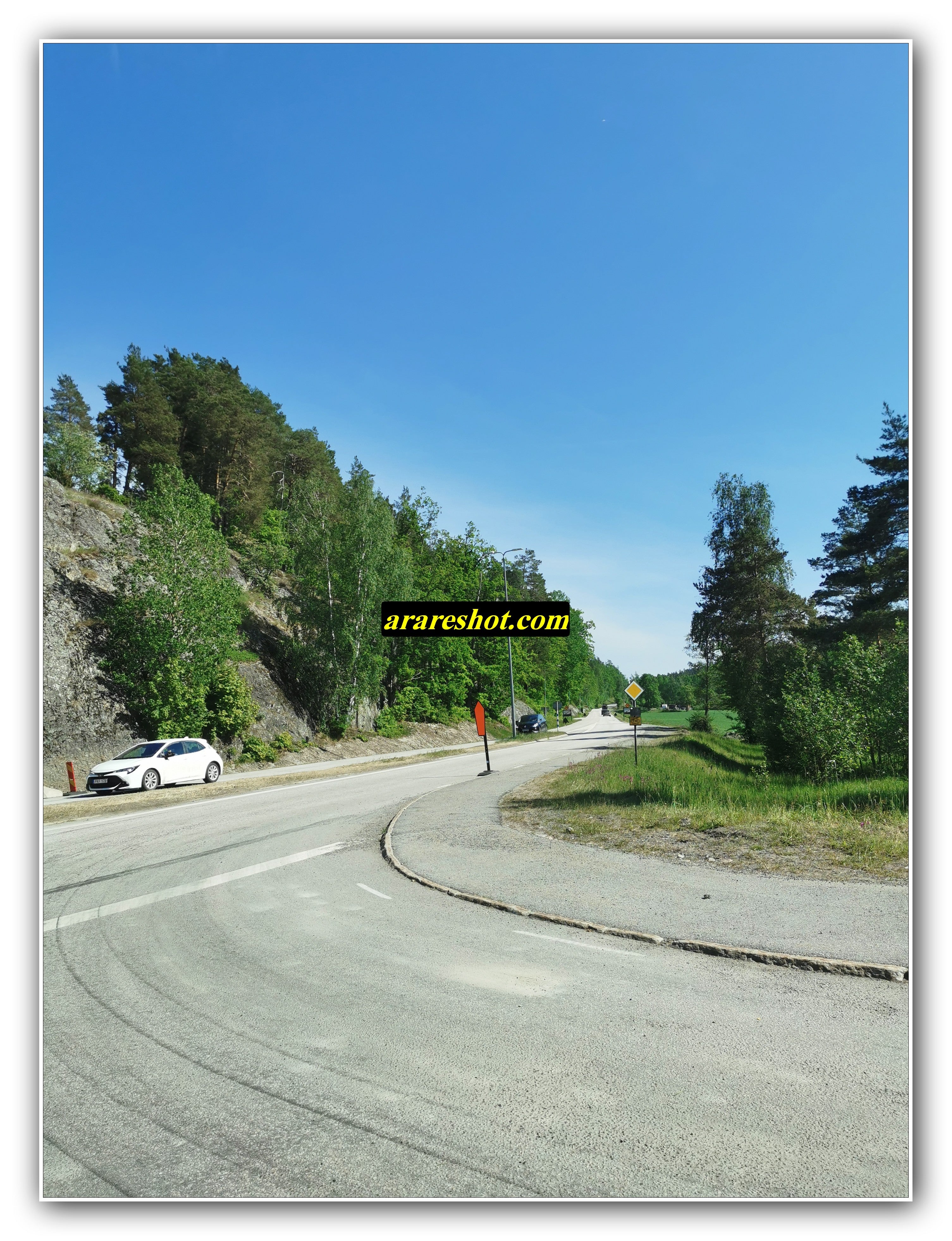Rural Curved Road with Parked Car