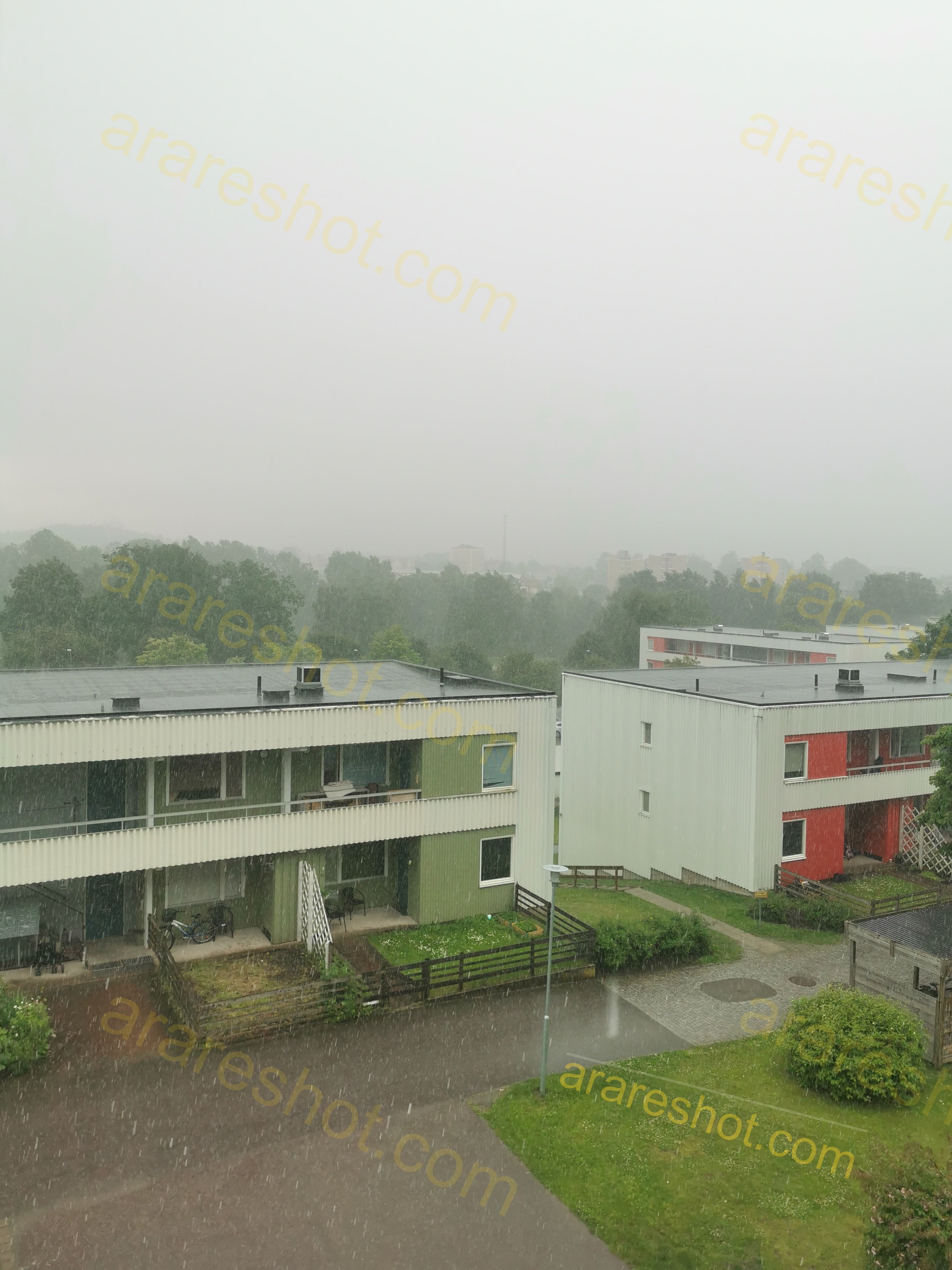 Residential Buildings with Green Lawns in Rain
