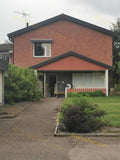 Two-Story Brick House with Front Lawn and Driveway