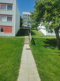 Concrete Path with Stairs Between Residential Buildings