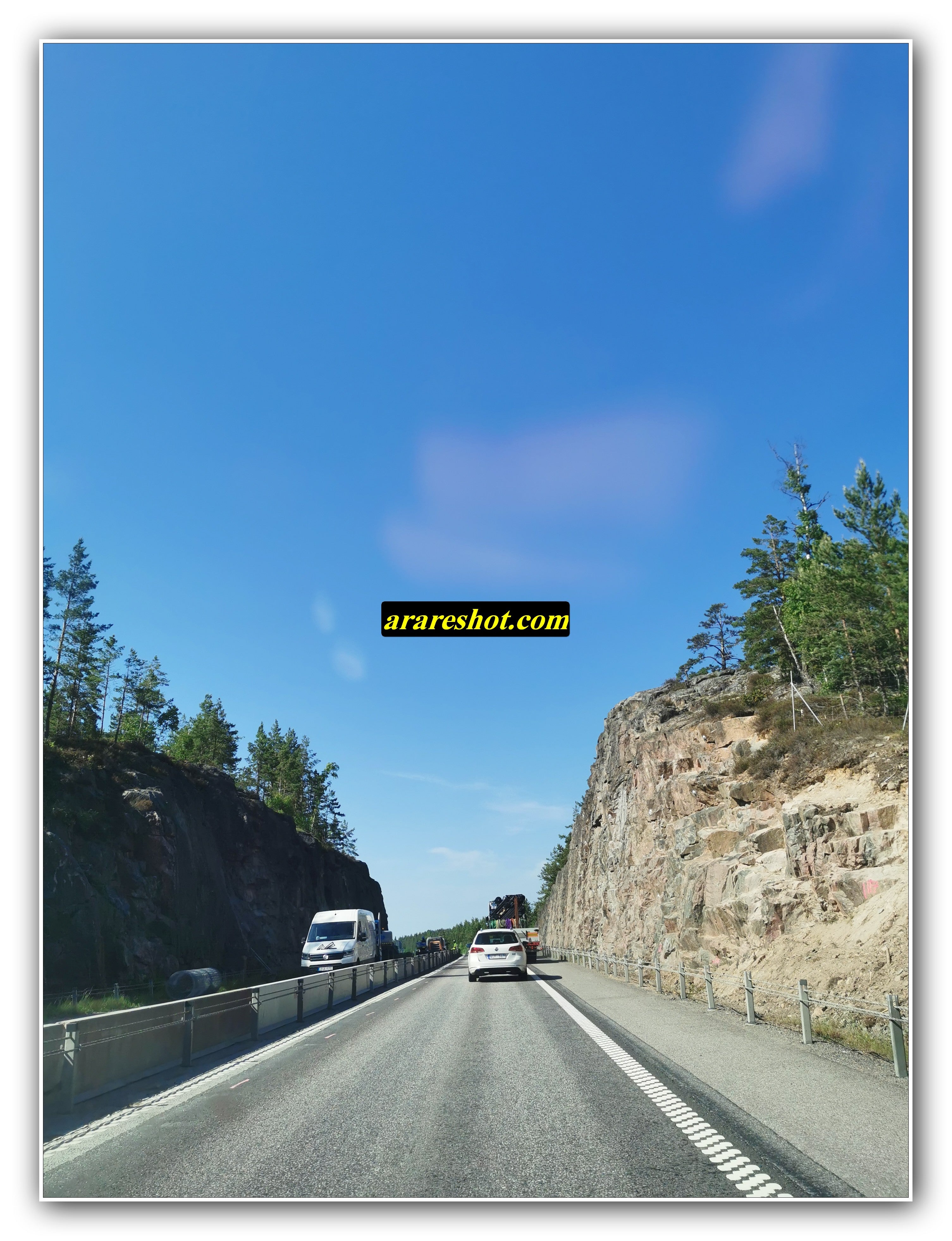 Highway Passage Carved Through Rocky Cliffs