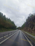 Empty Road with Road Divider and Rock Cliff