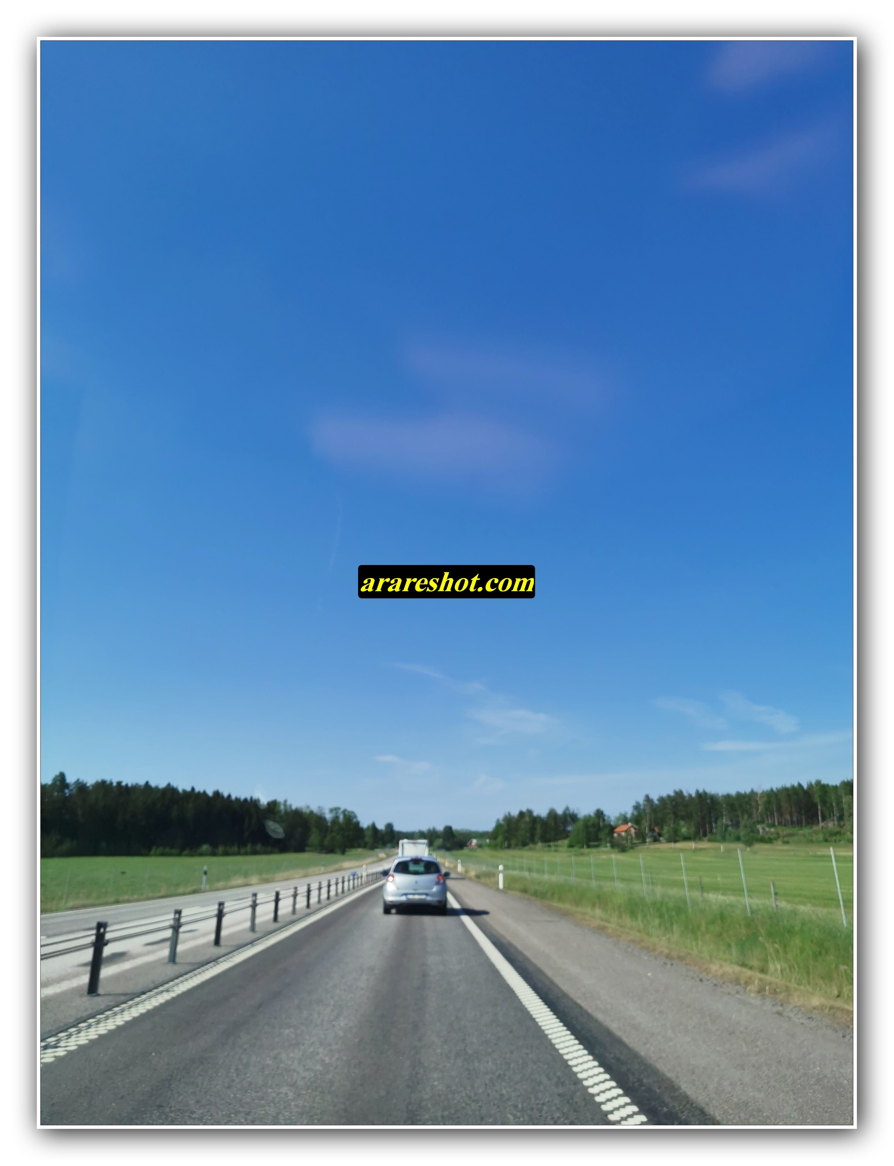 Rural Highway Drive Across Open Green Fields