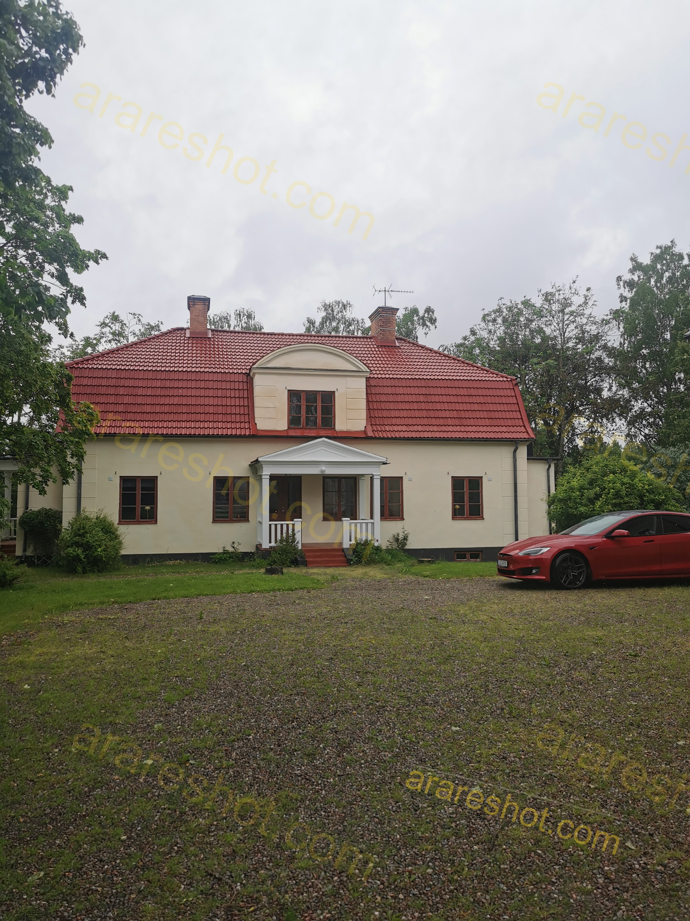 Two-Story House with Red Roof and Front Porch