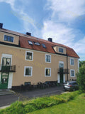 Residential Building with Red Roof and Green Doors