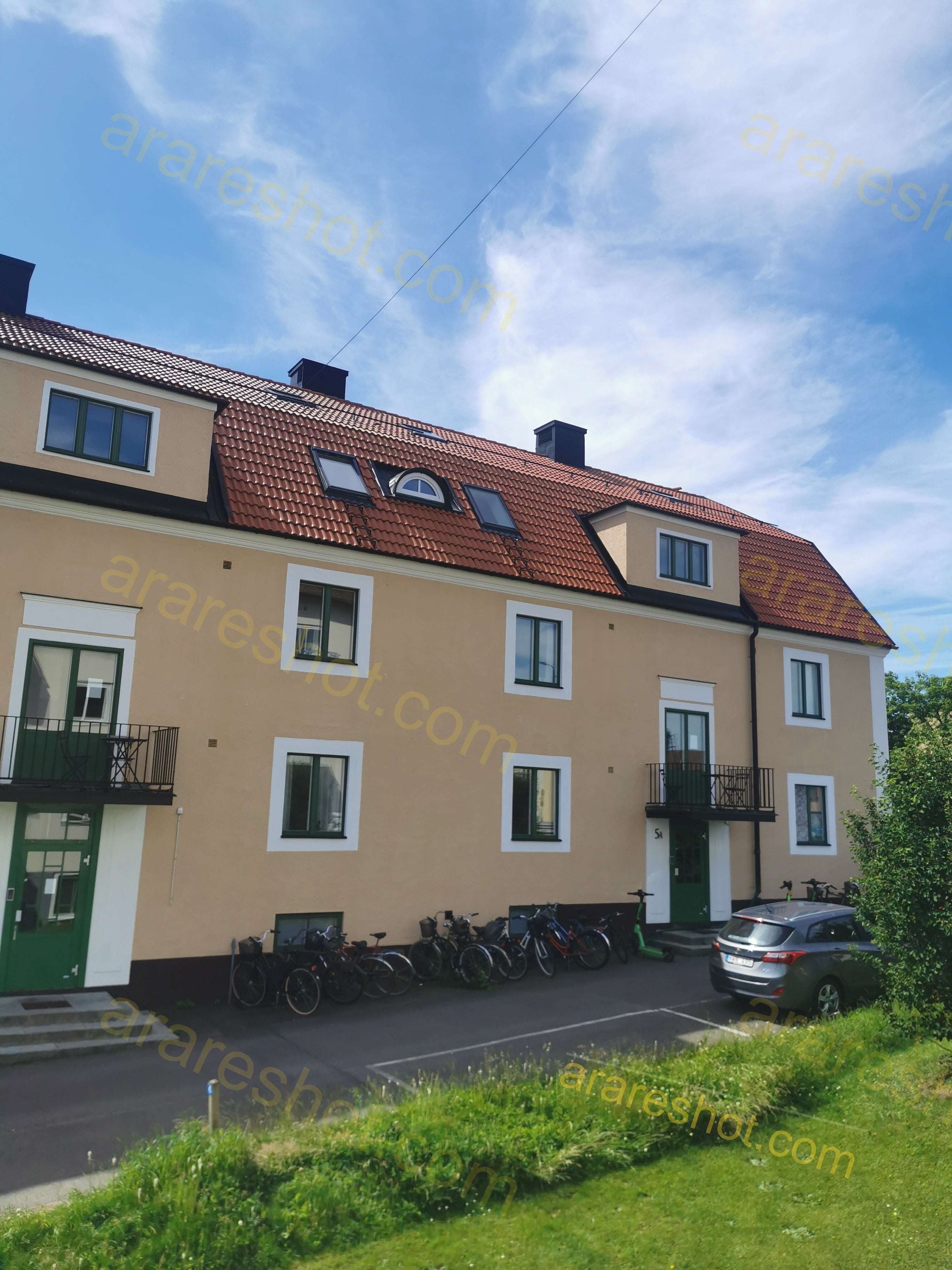 Residential Building with Red Roof and Green Doors