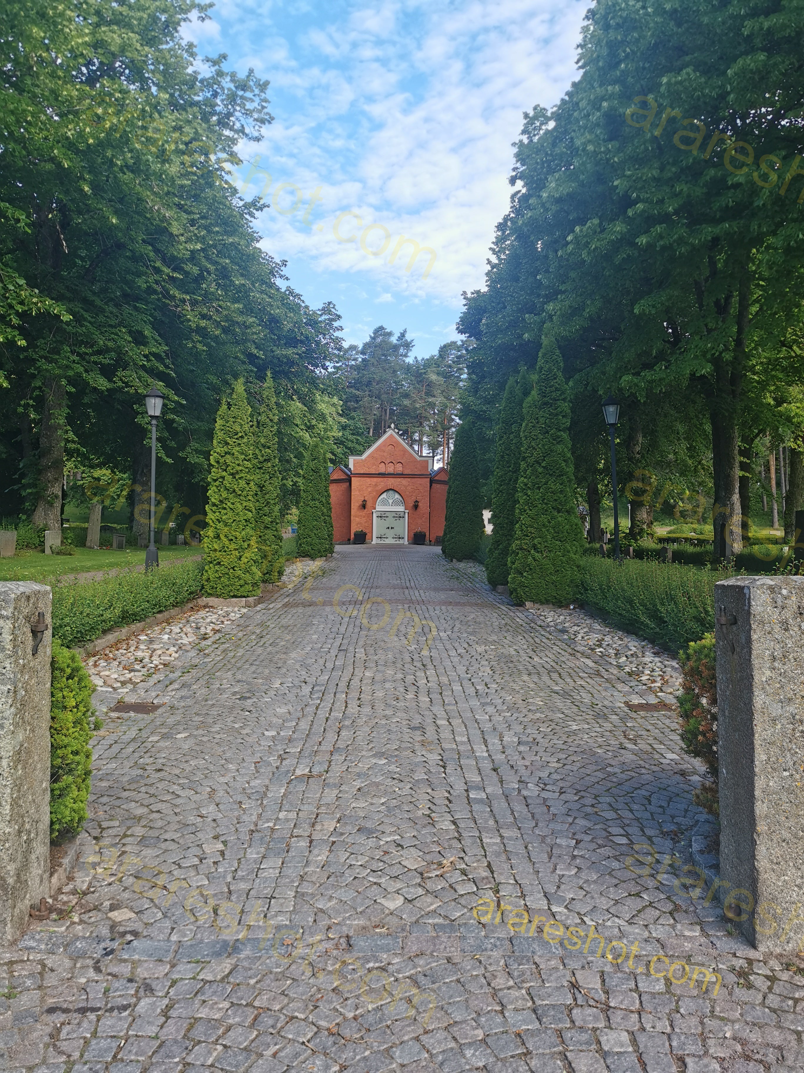 Historic Red Brick Chapel Surrounded by Evergreen Trees