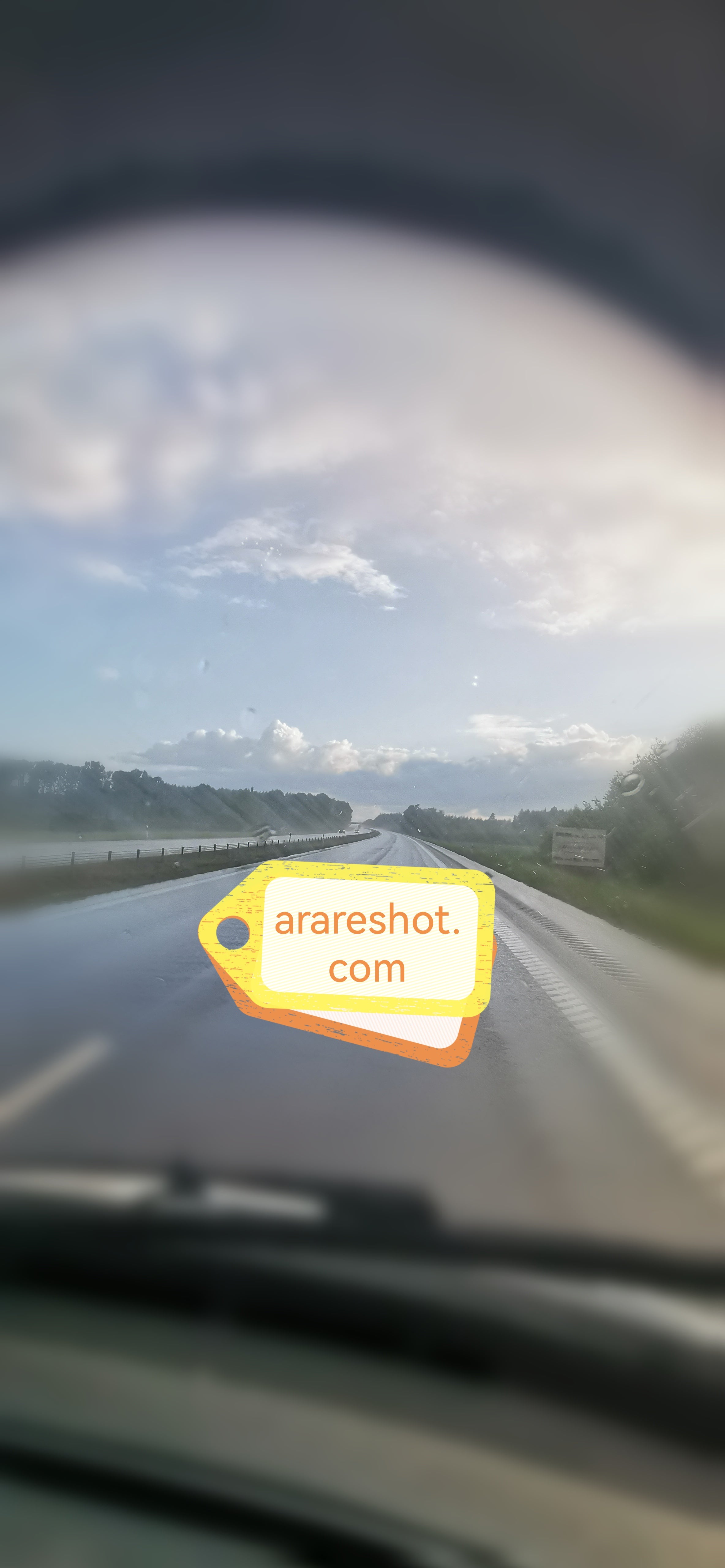 Wet Highway Under Clearing Sky