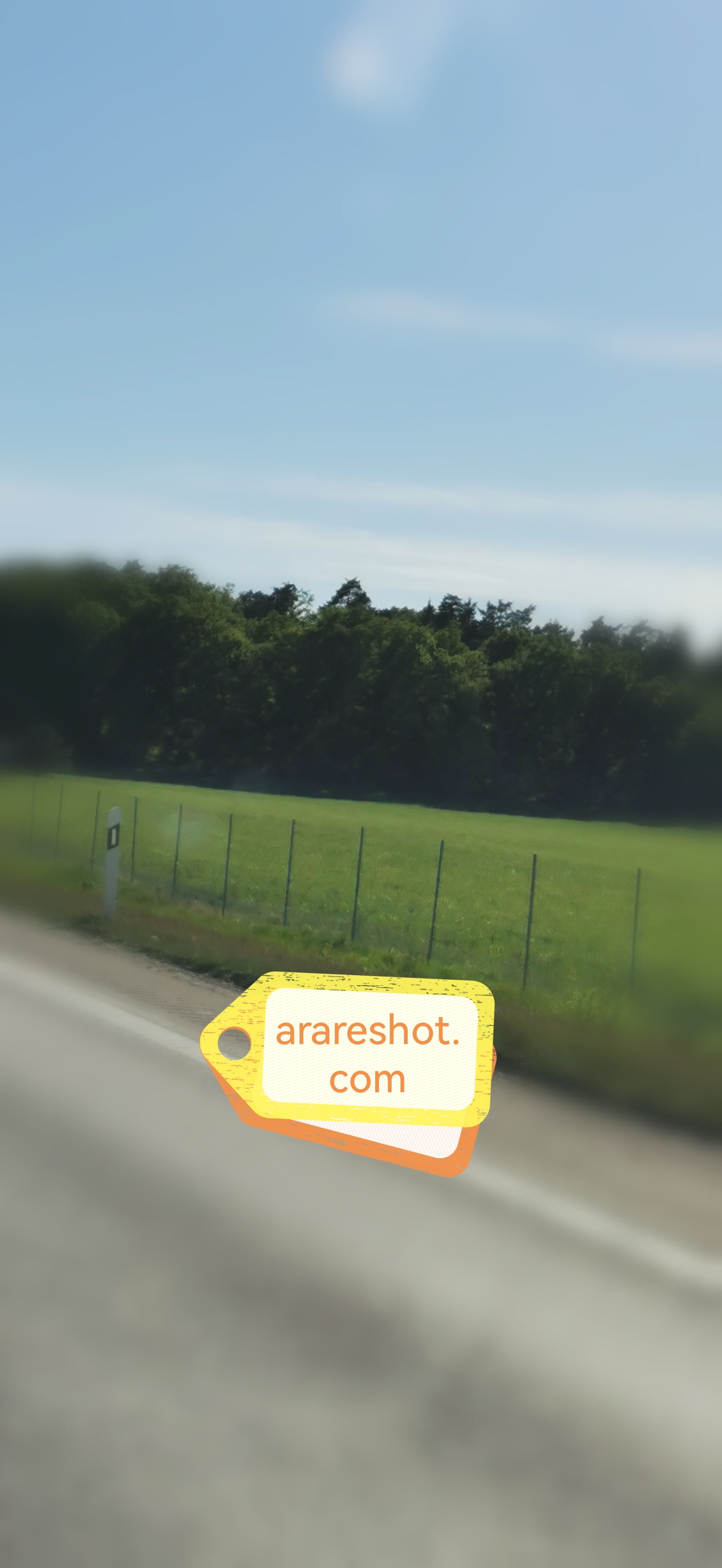 Country Road Beside Green  Field Under Clear Sky
